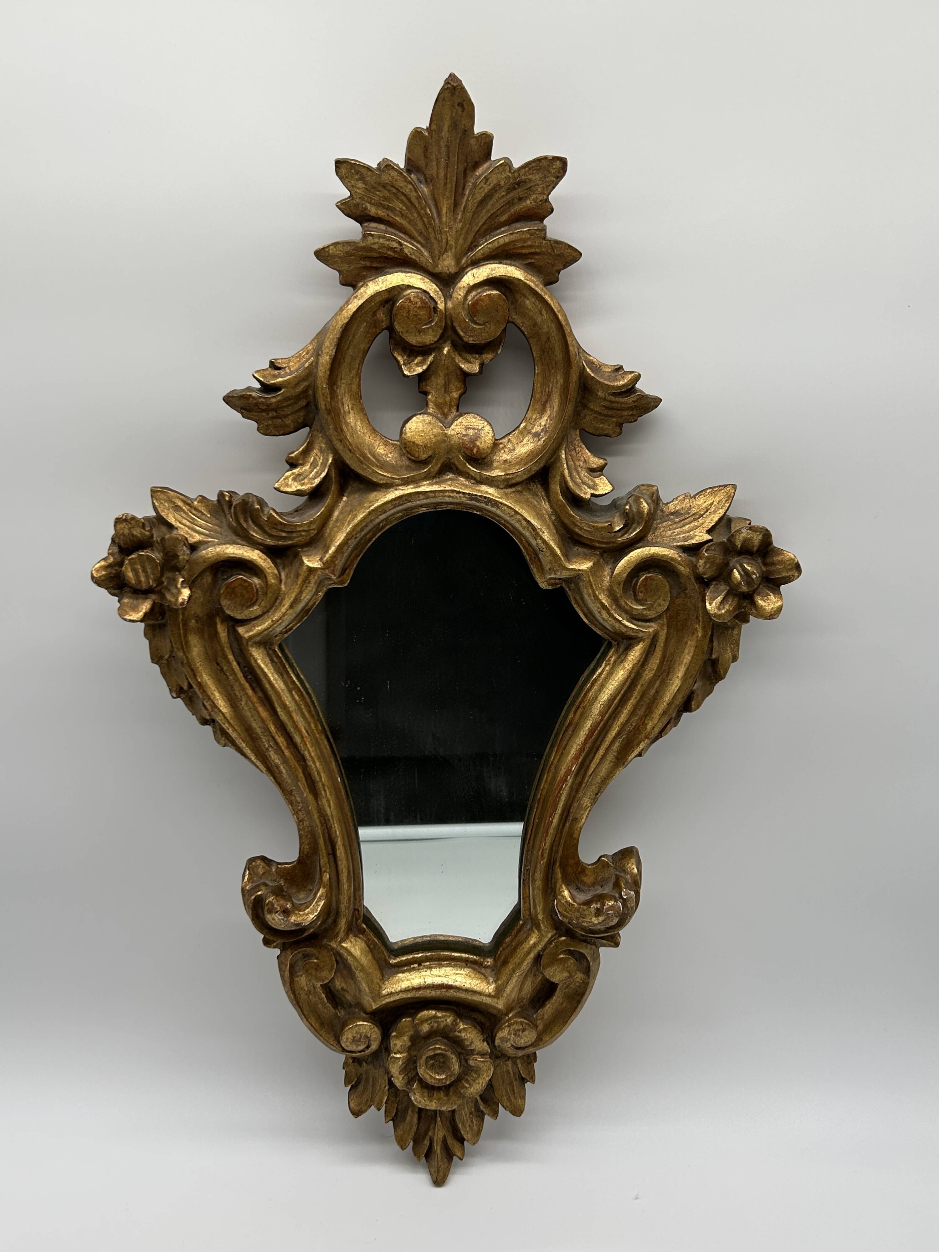Wooden mirror with gilded stucco