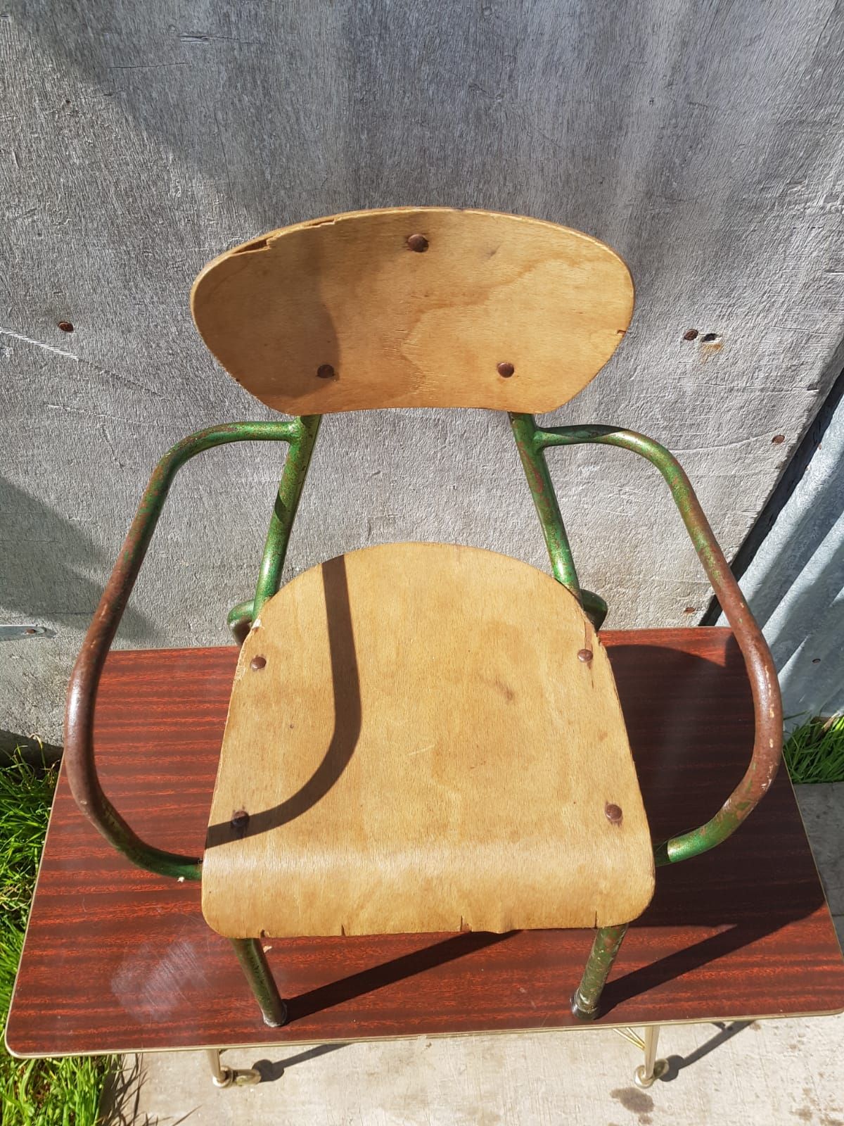 Former green metal child chair