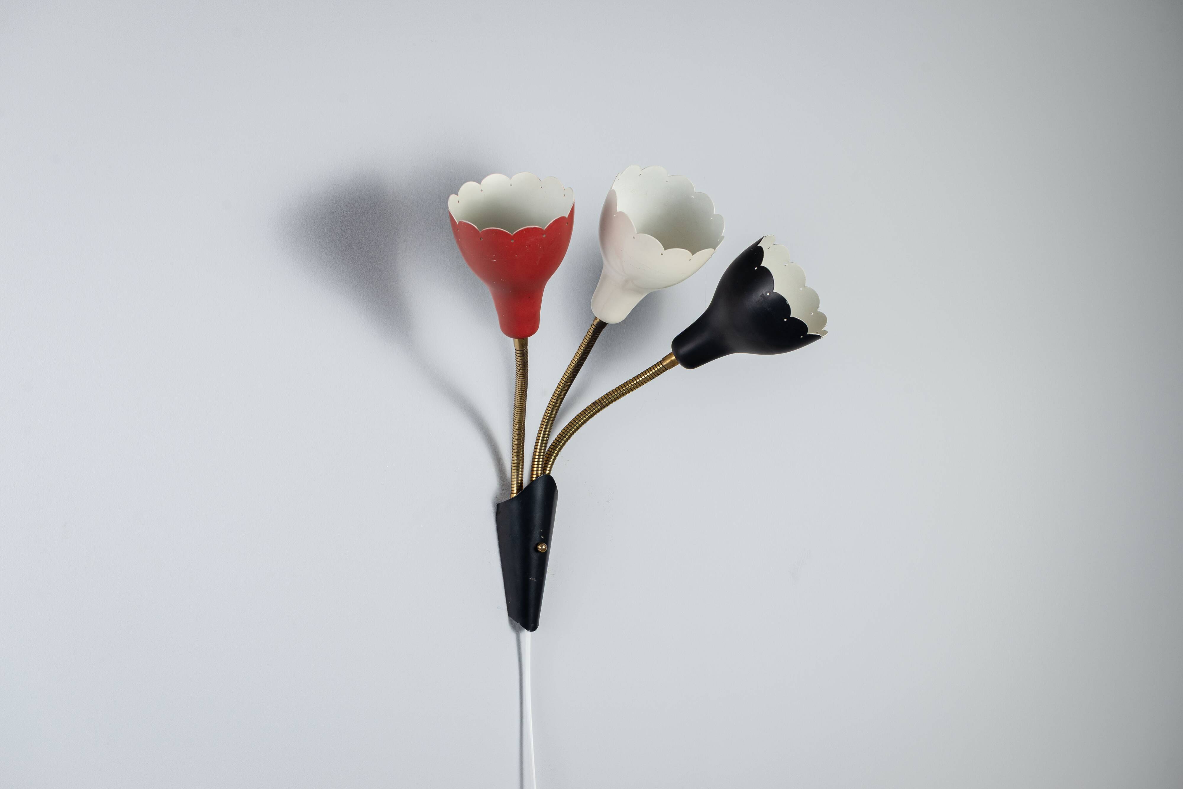 Adjustable wall lamp with three decorated shades in different colours