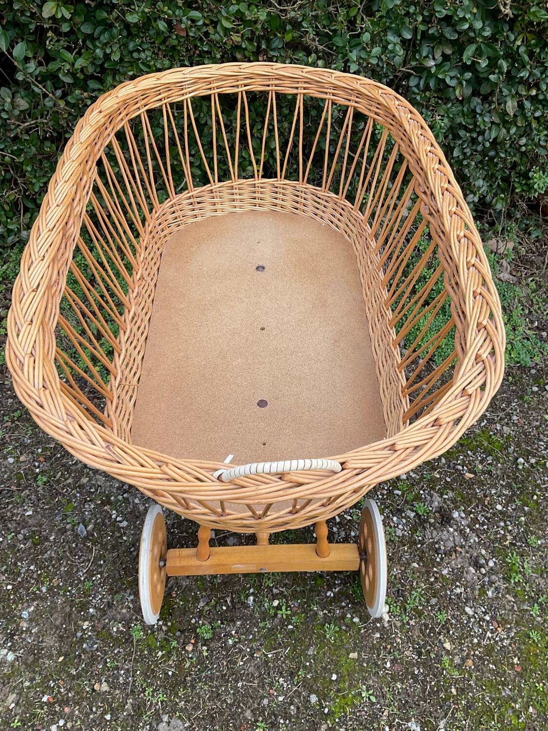 Vintage wicker cradle on casters