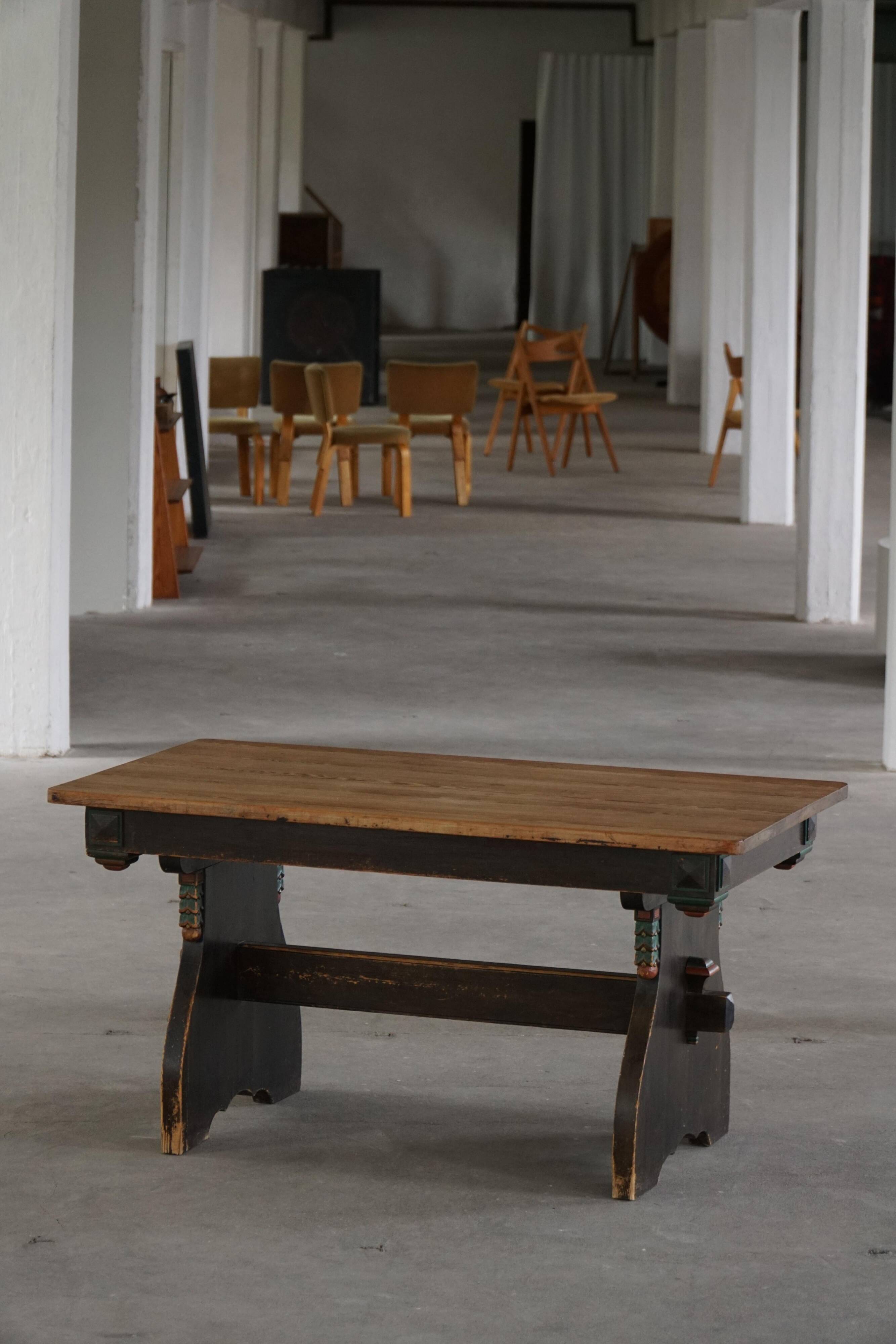 Rustic Scandinavian dining table in stained pine, Sweden, 1900-1940.