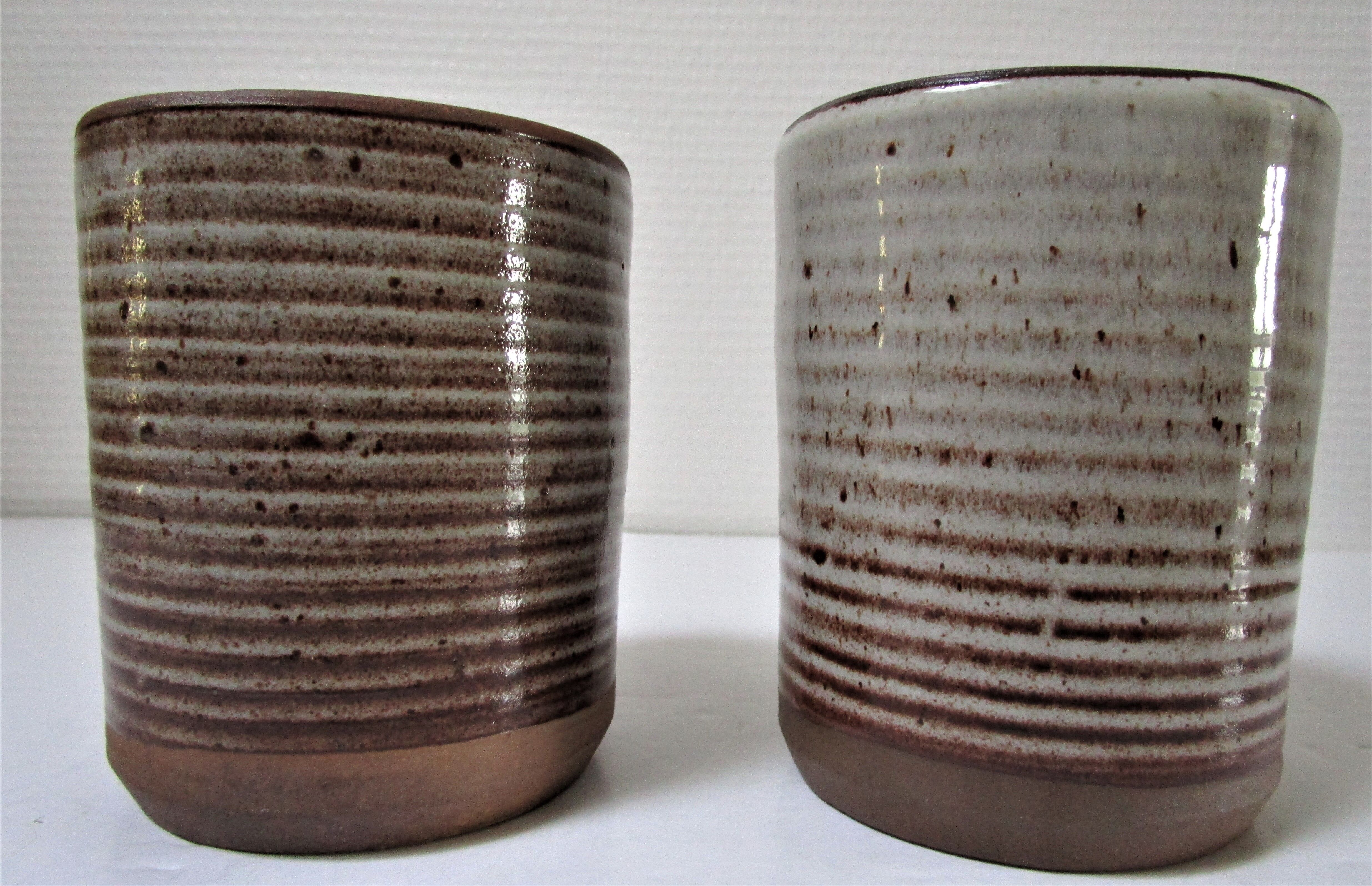 Two enamelled sandstone mugs Roger Jacques handwritten signature