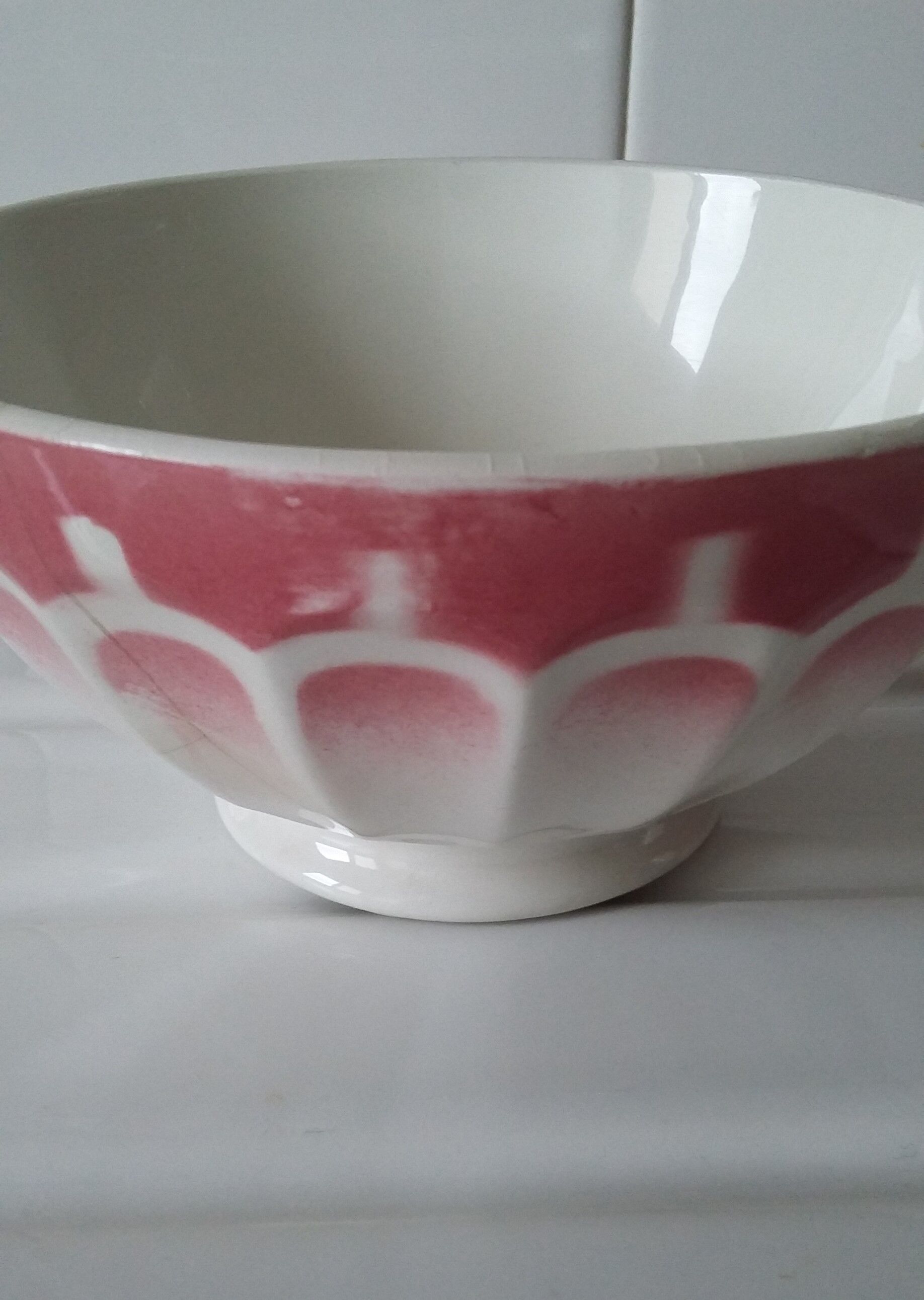 Ancient bowl in pink and white earthenware