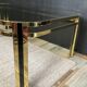 Table basse vintage années 70 en métal doré et verre fumé