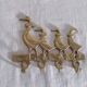 Wall-mounted tea towel holder or key holder in brass with ducks.