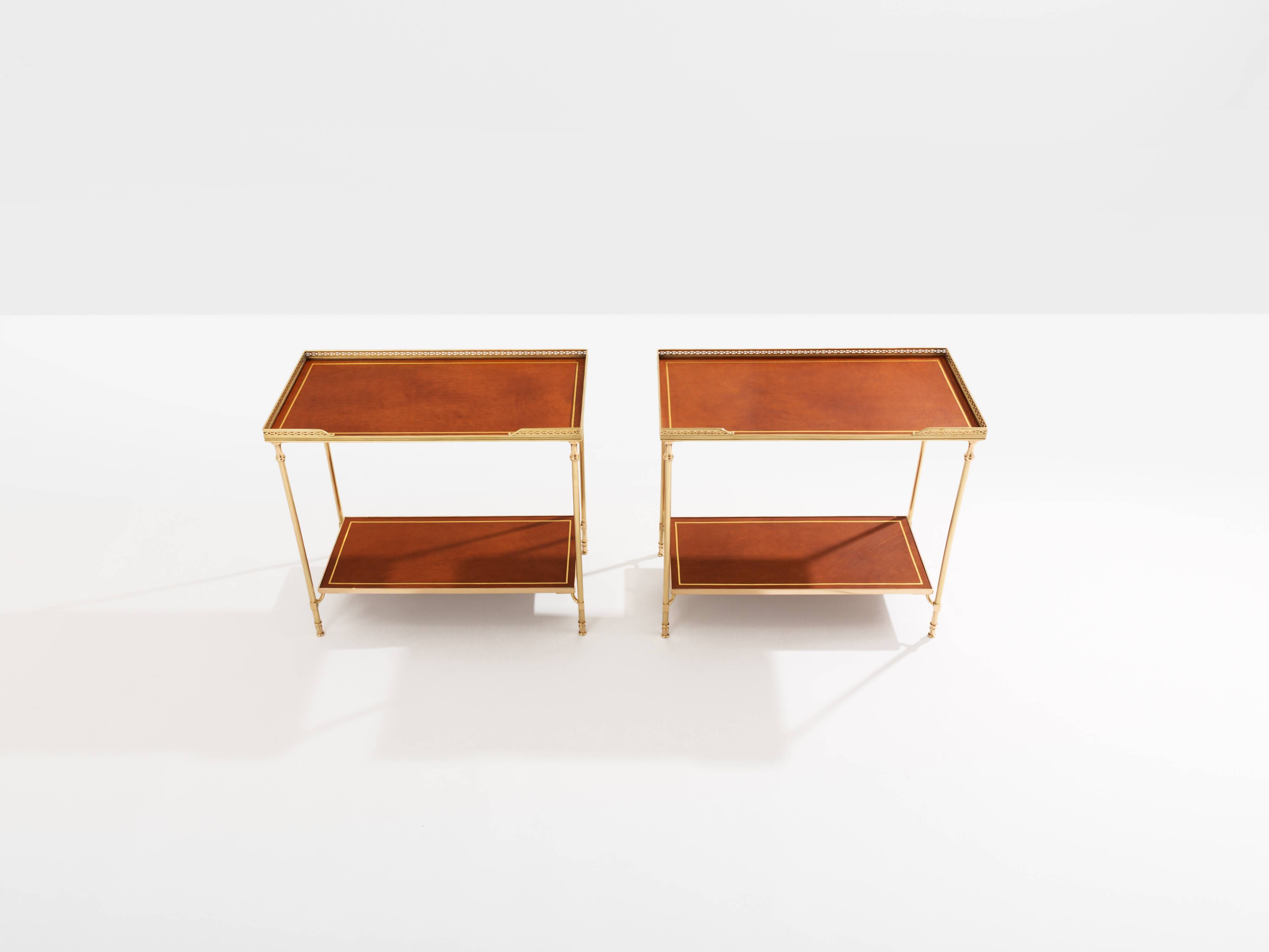Pair of neoclassical brass and leather side tables by Maison Jansen, 1960