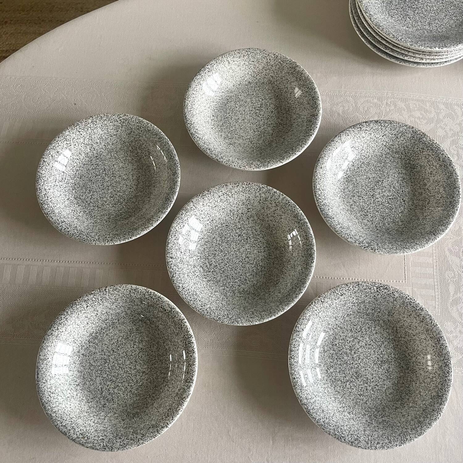 12 speckled ceramic plates.