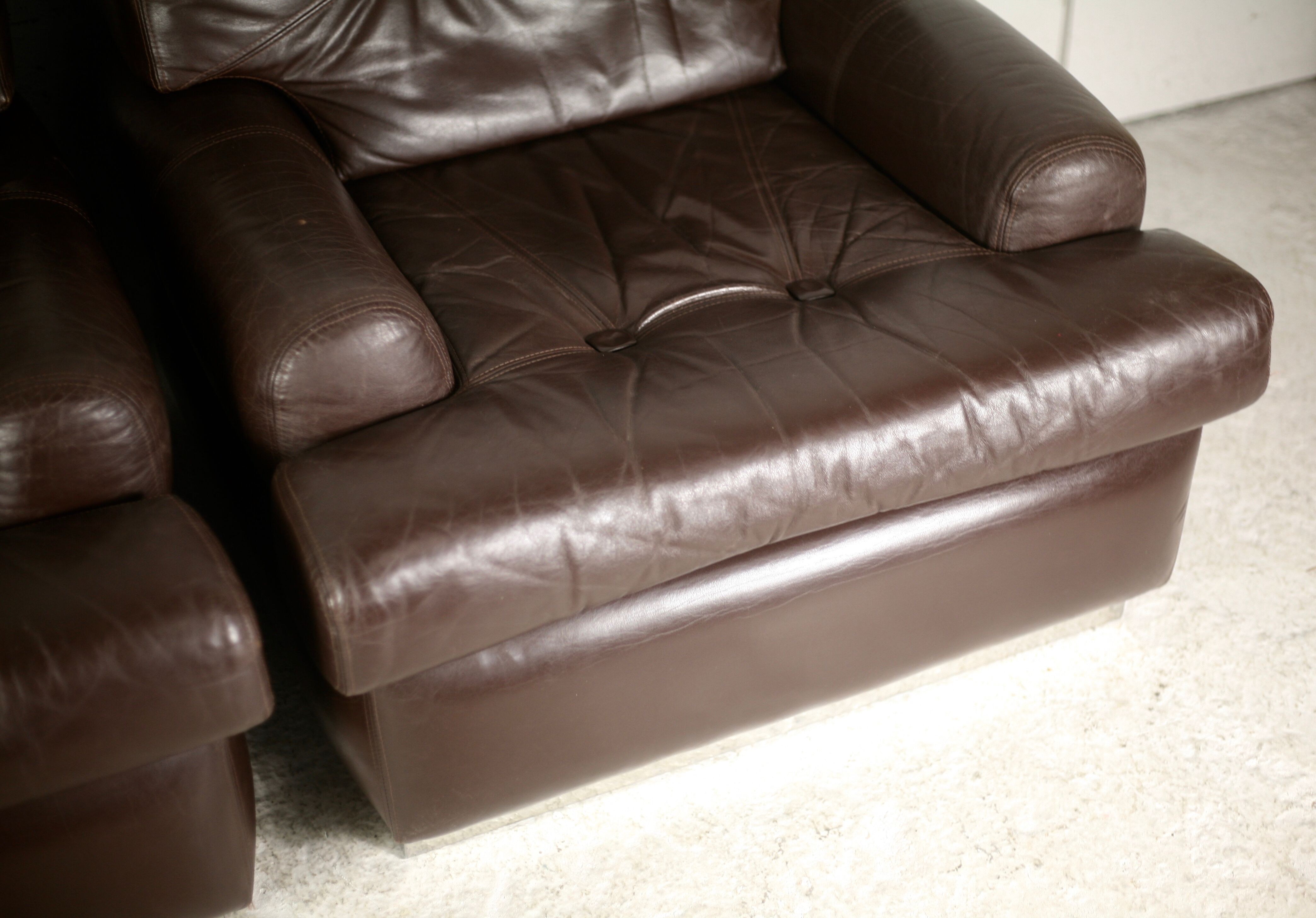 Pair of armchairs brown leather base stainless steel, France, circa 1970