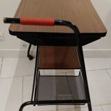 Red scoubidou handles wheeled serving table