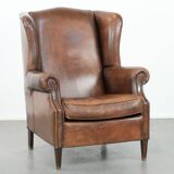Vintage wingback armchair made of sheepskin leather with beautiful colours