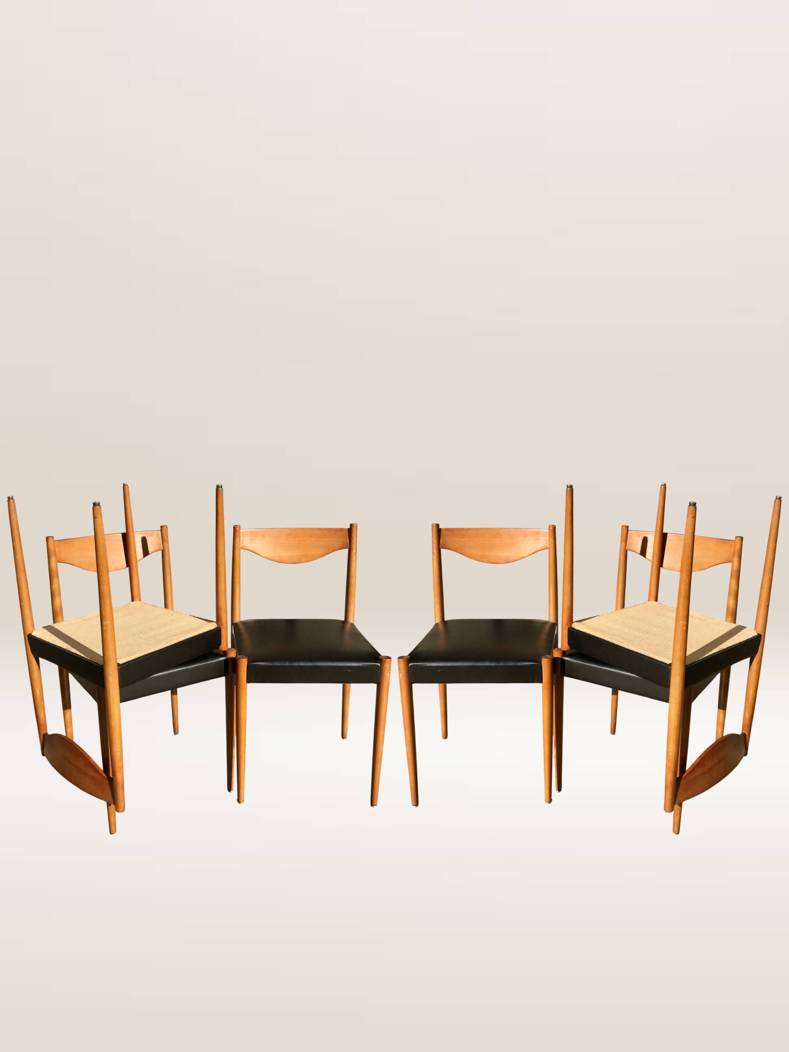 Set of 6 modernist chairs with black faux leather seats.