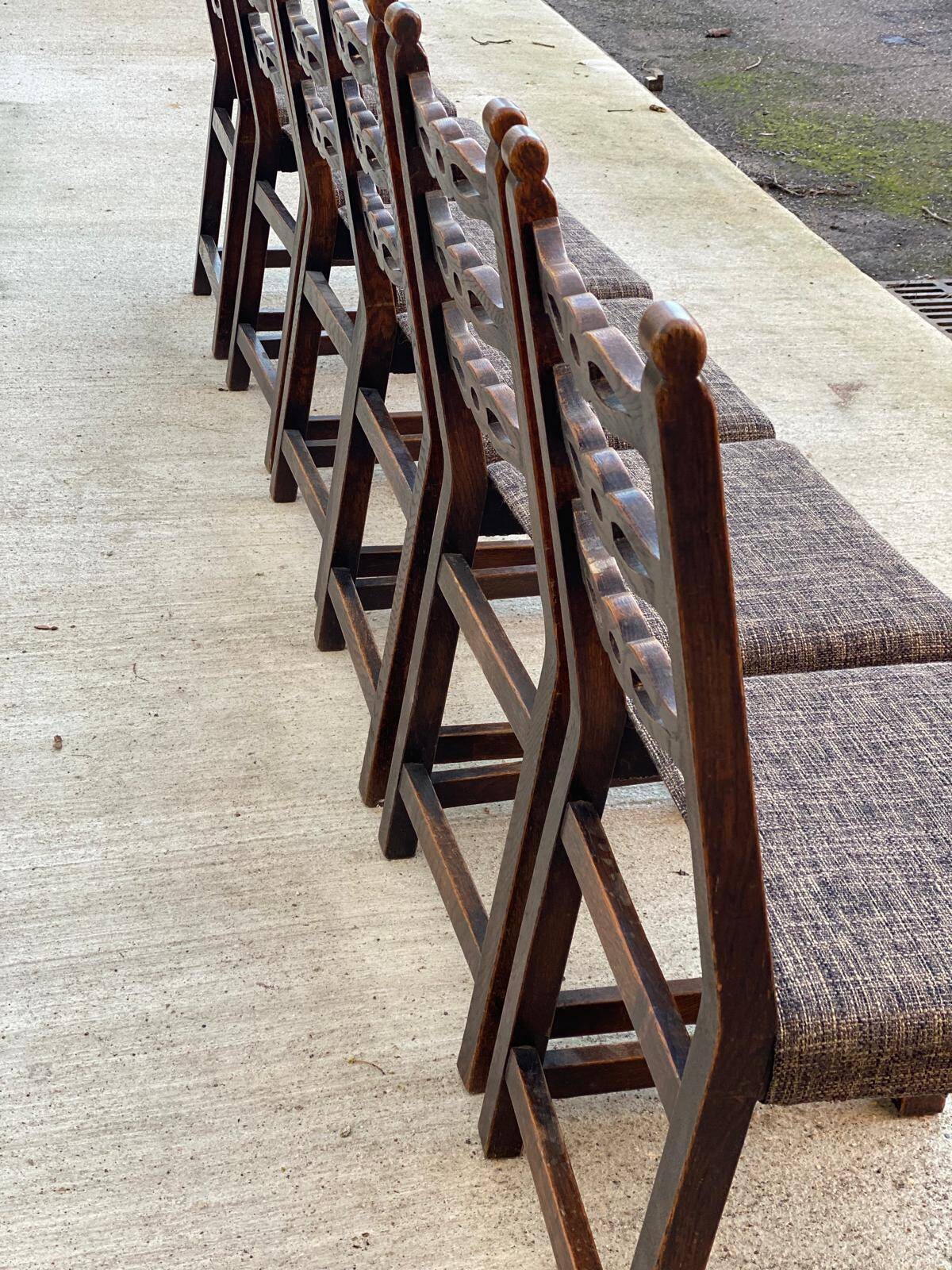 6 solid wood dining chairs with grey woven wool seats.