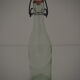 Bottle with mechanical closure in white glass