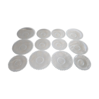 Vintage service of 12 pressed glass plates with bead decoration.