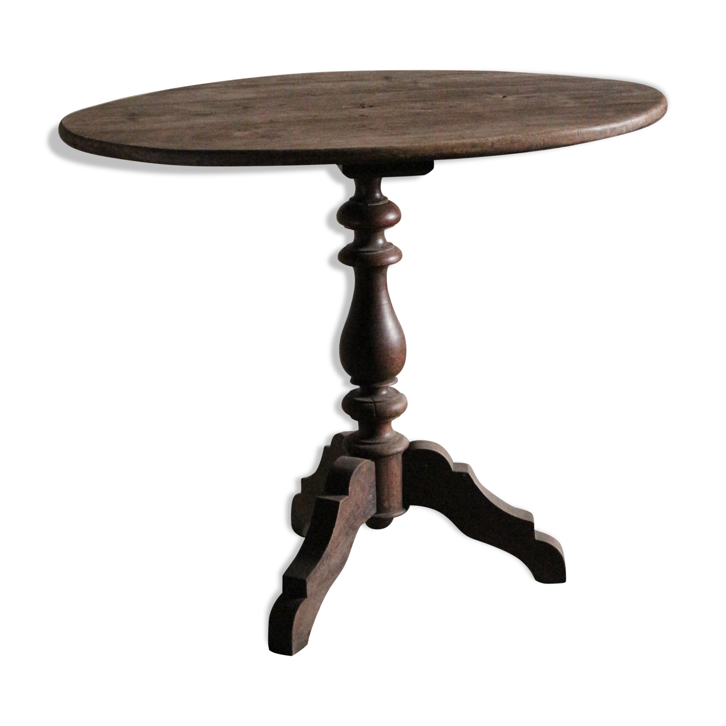 Old oval pedestal table in raw wood