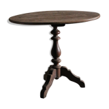 Old oval pedestal table in raw wood