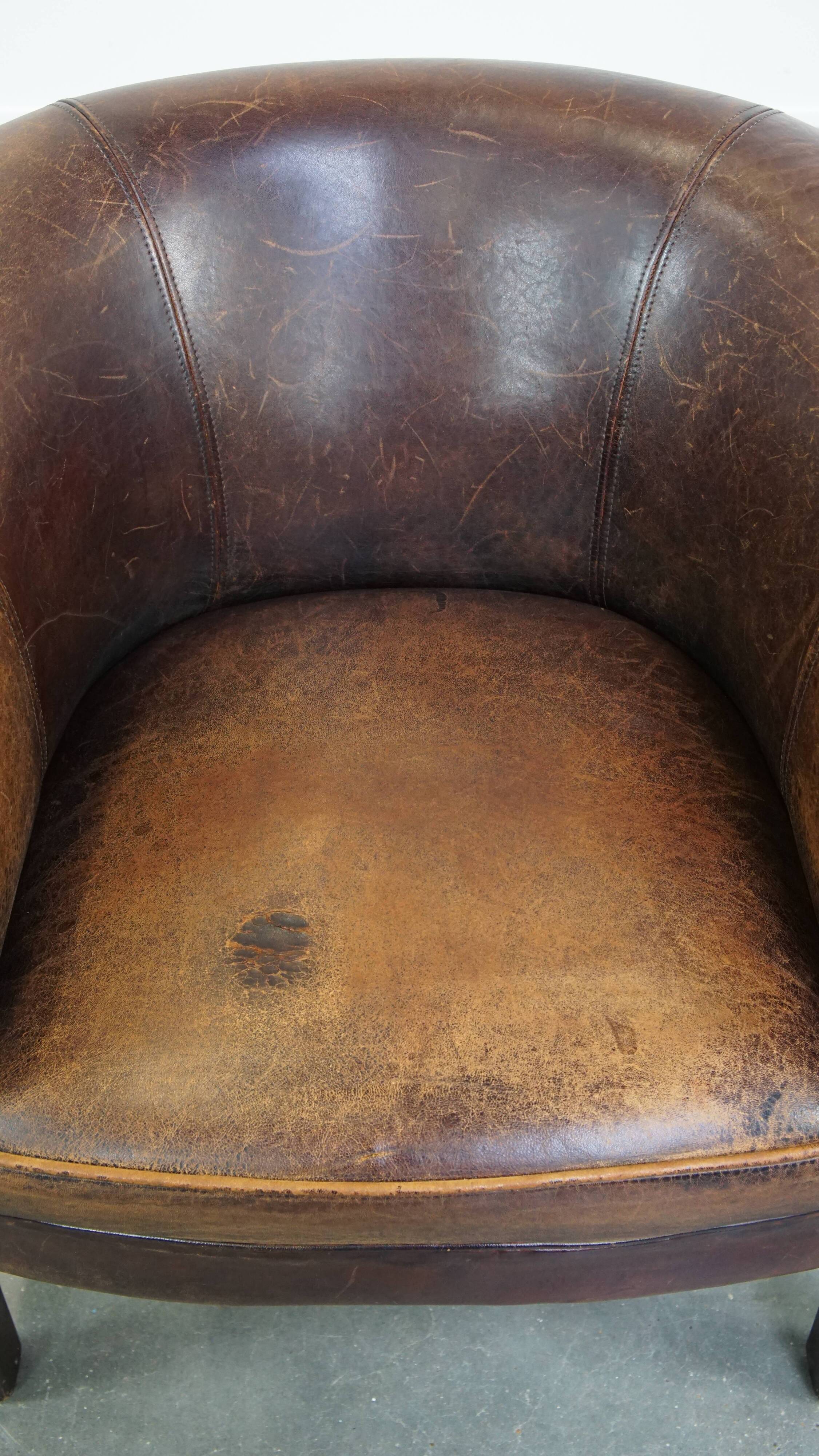Sheep leather club chair finished with decorative nails