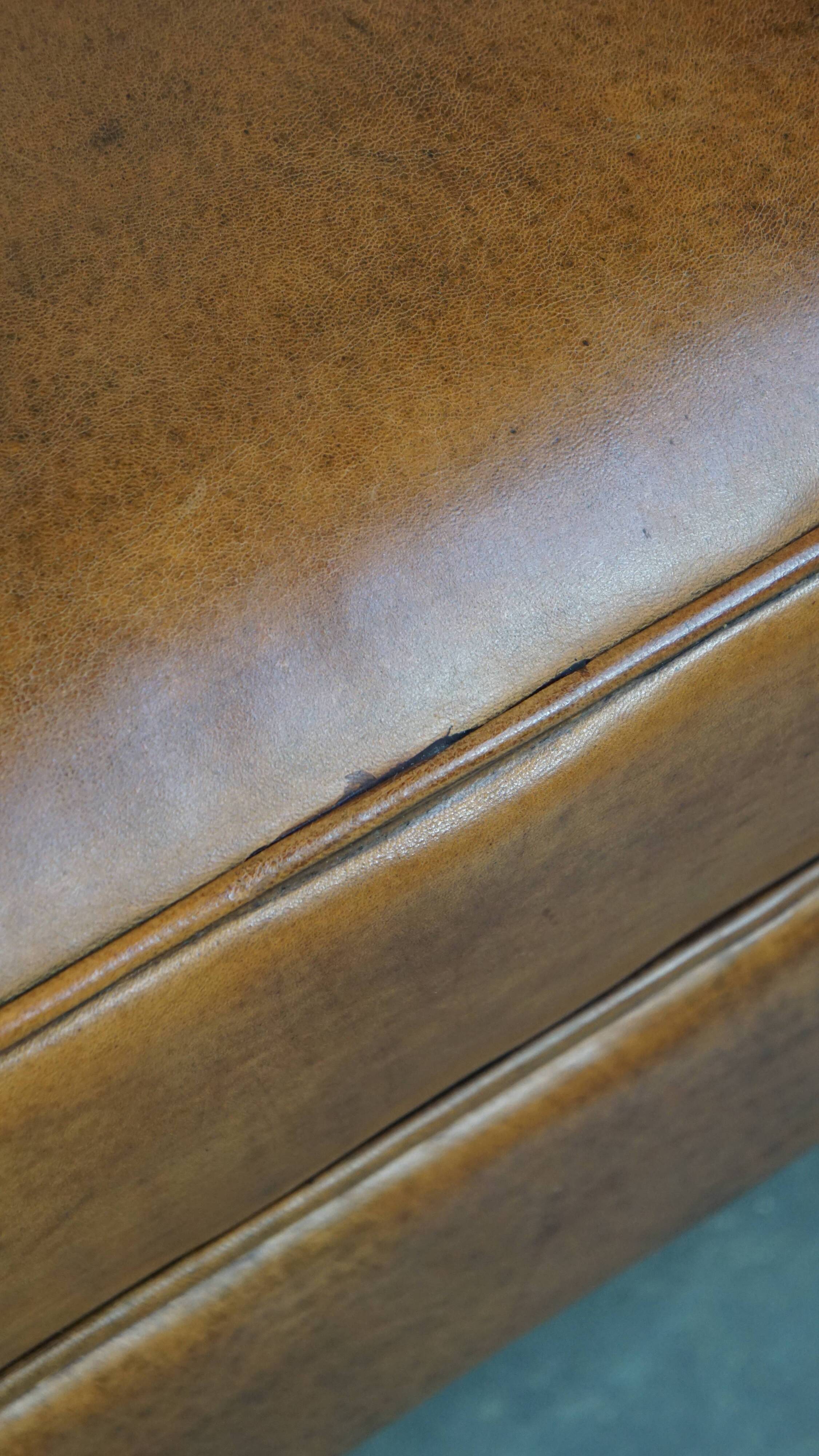 Cognac-colored sheepskin and wooden Art Deco design armchair