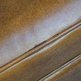 Cognac-colored sheepskin and wooden Art Deco design armchair