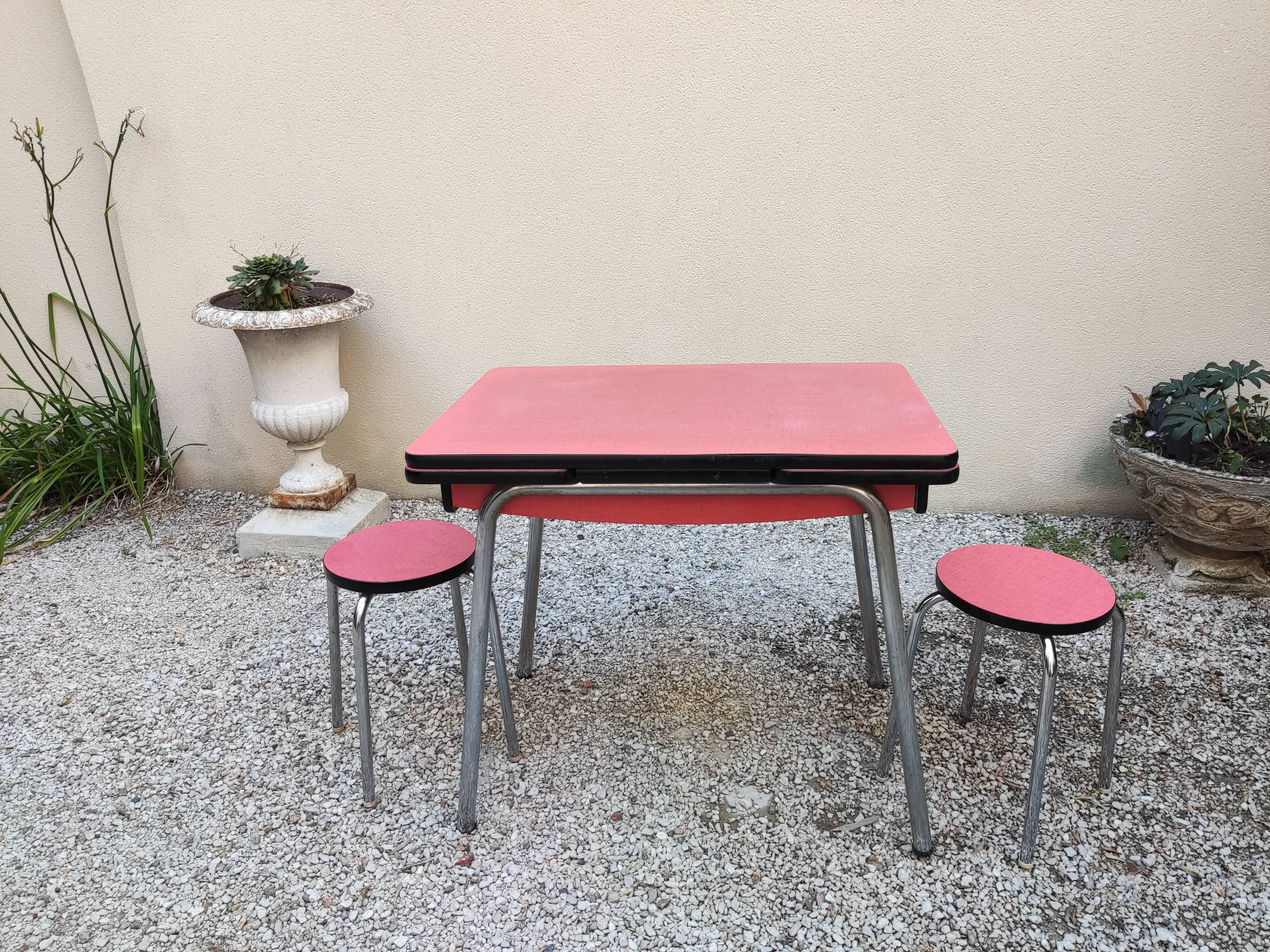 Table with two stools in red formica