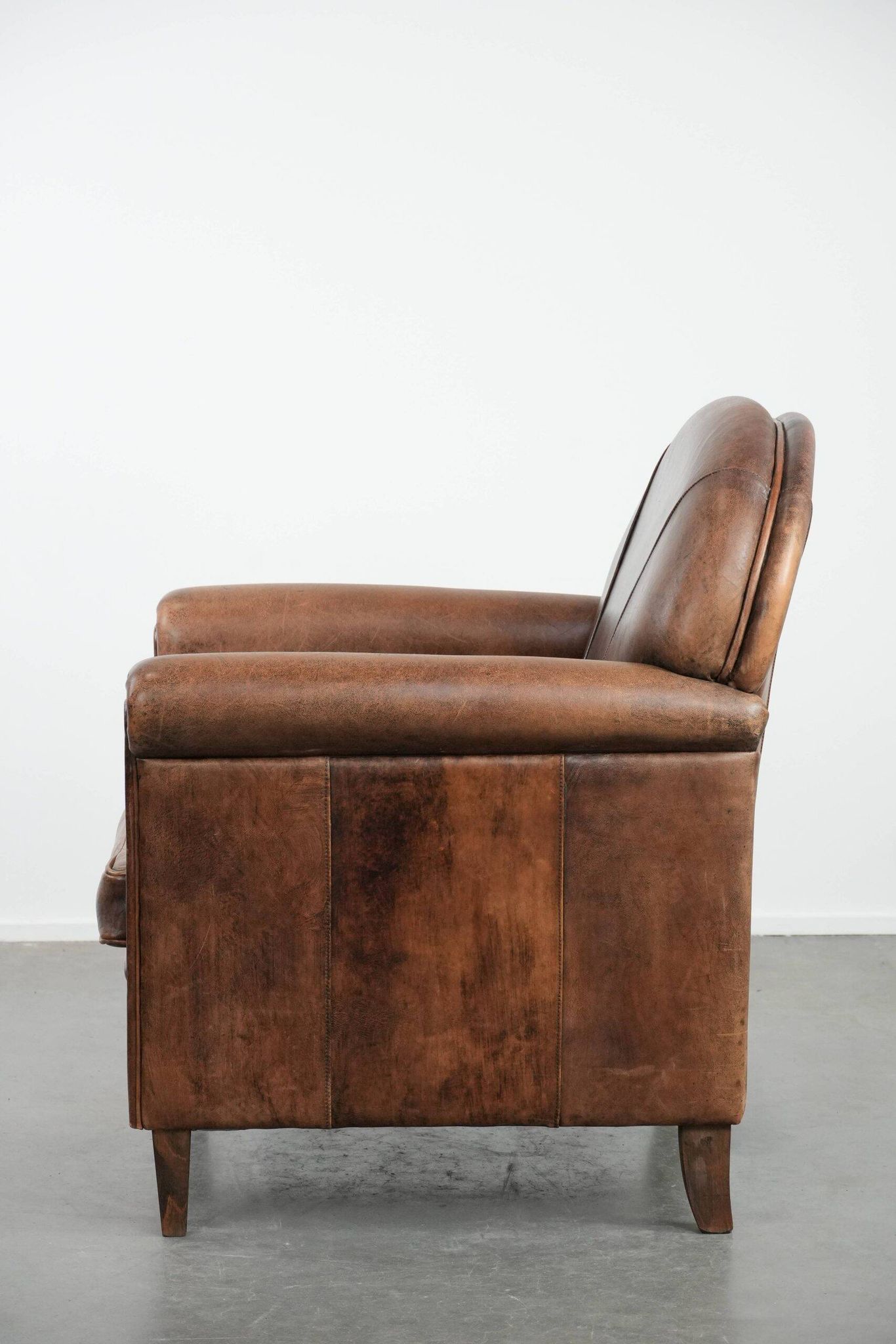 Vintage sheepskin armchair with warm colours and a characterful appearance