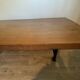 Industrial style table with a mahogany top.
