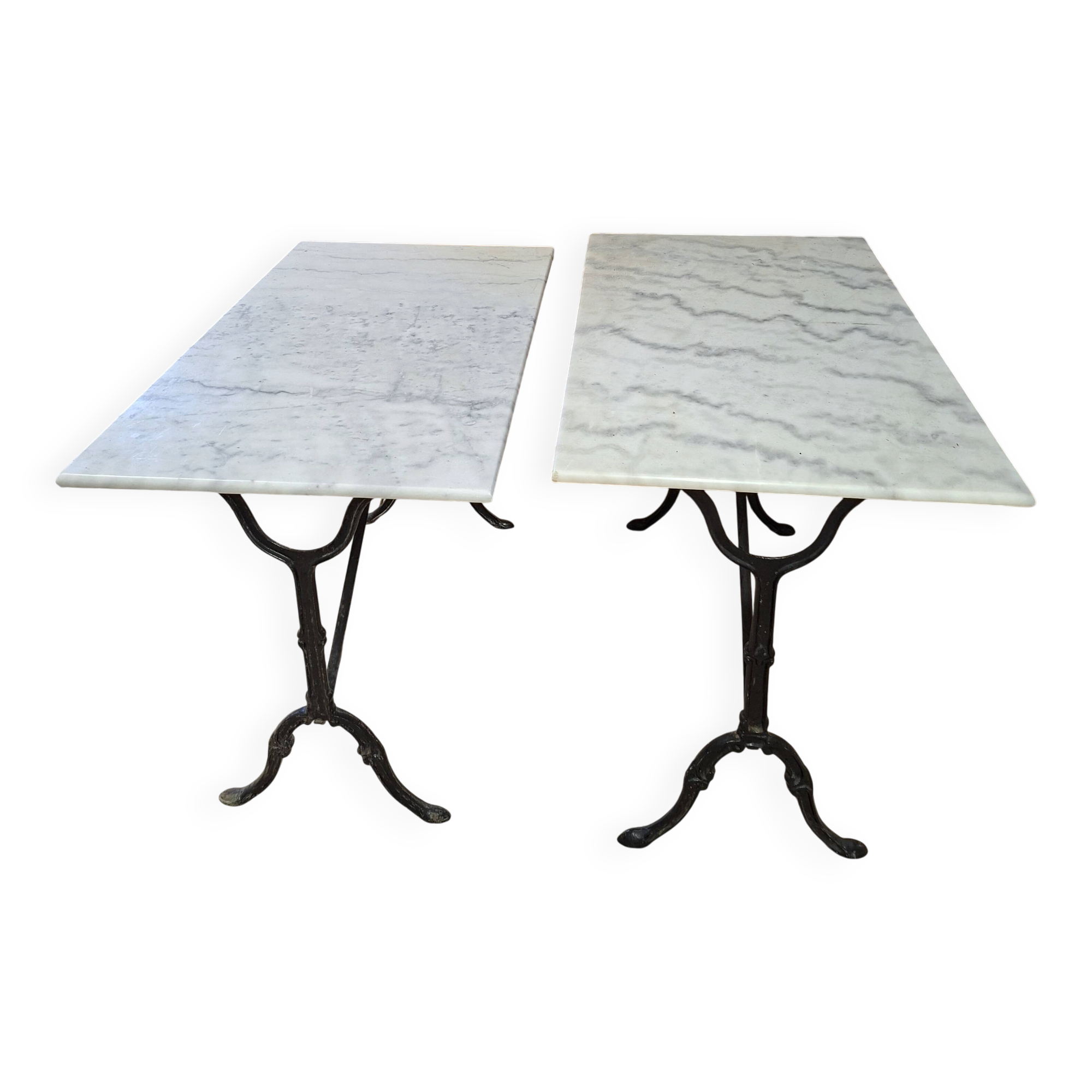 Pair of bistro tables in marble and cast iron.