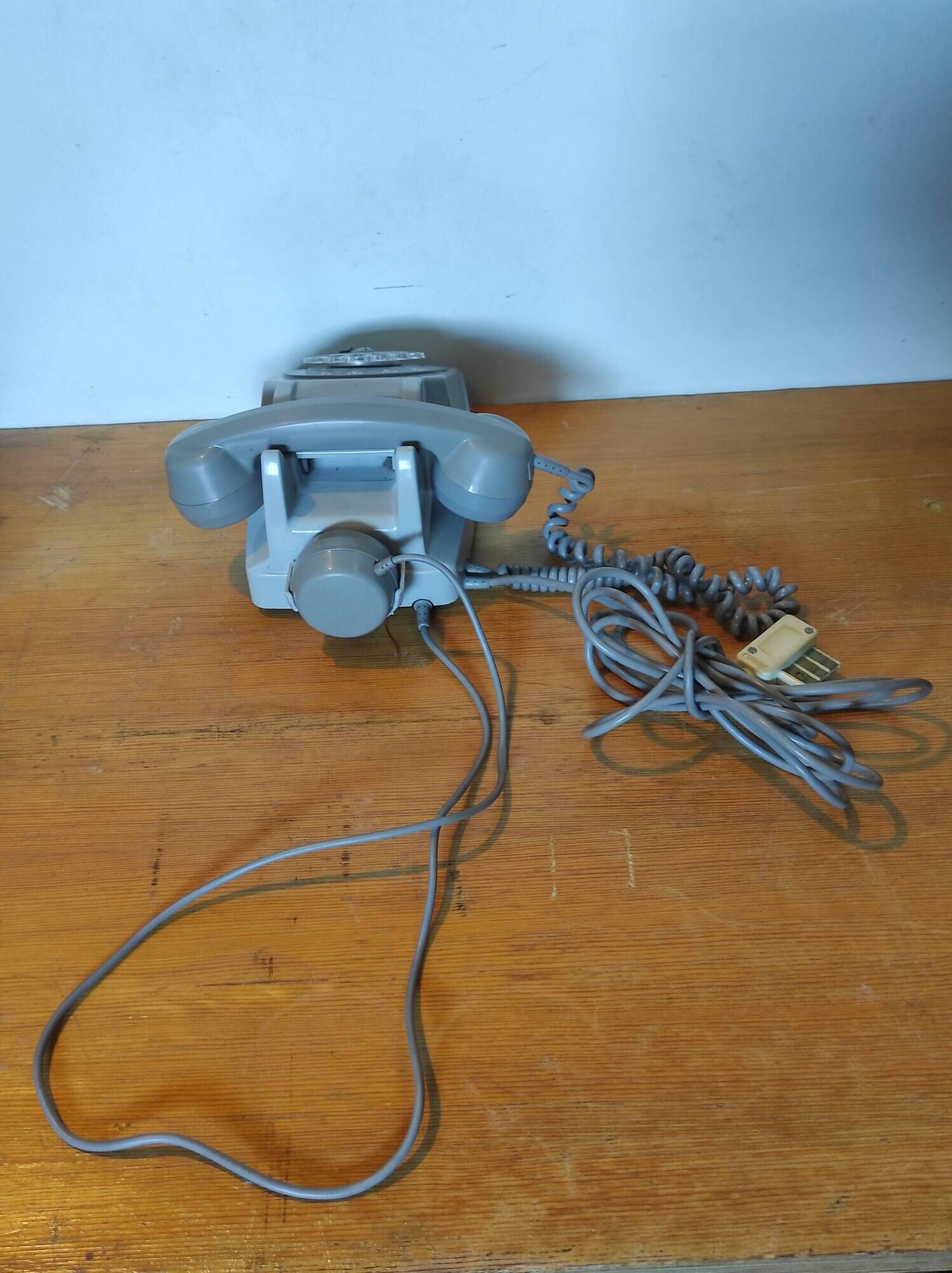 Old vintage wired dial phone with its earphone, gray color. Late 70s - early
