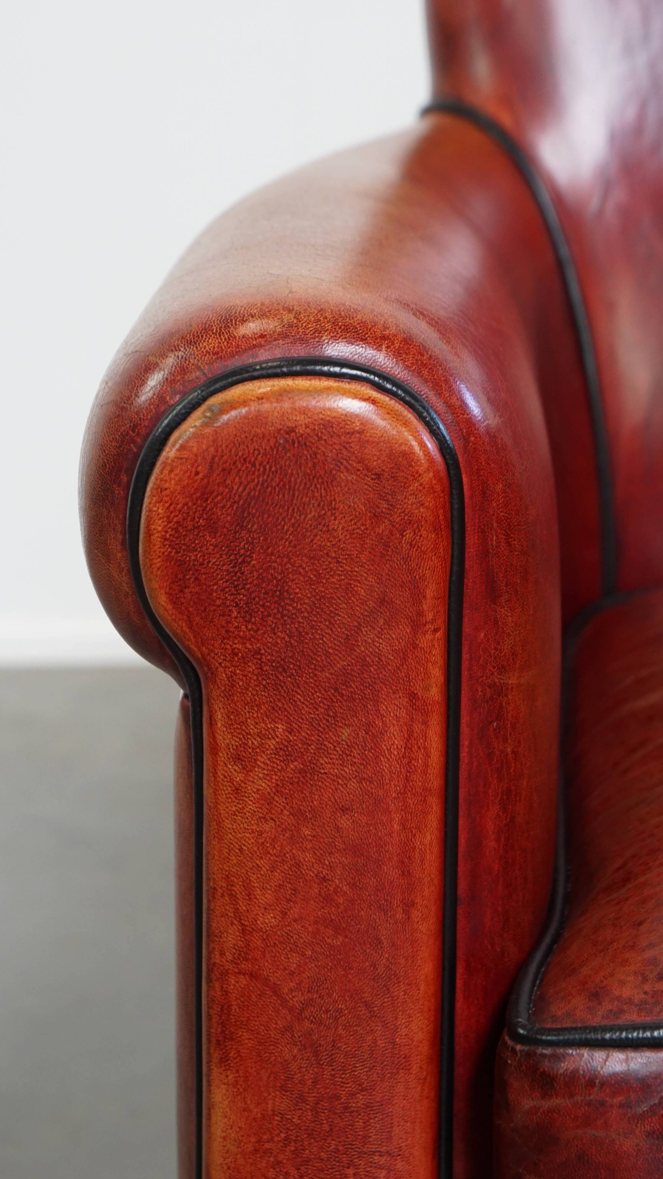 Armchair made of sheepskin leather in a red/brown color