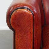 Armchair made of sheepskin leather in a red/brown color