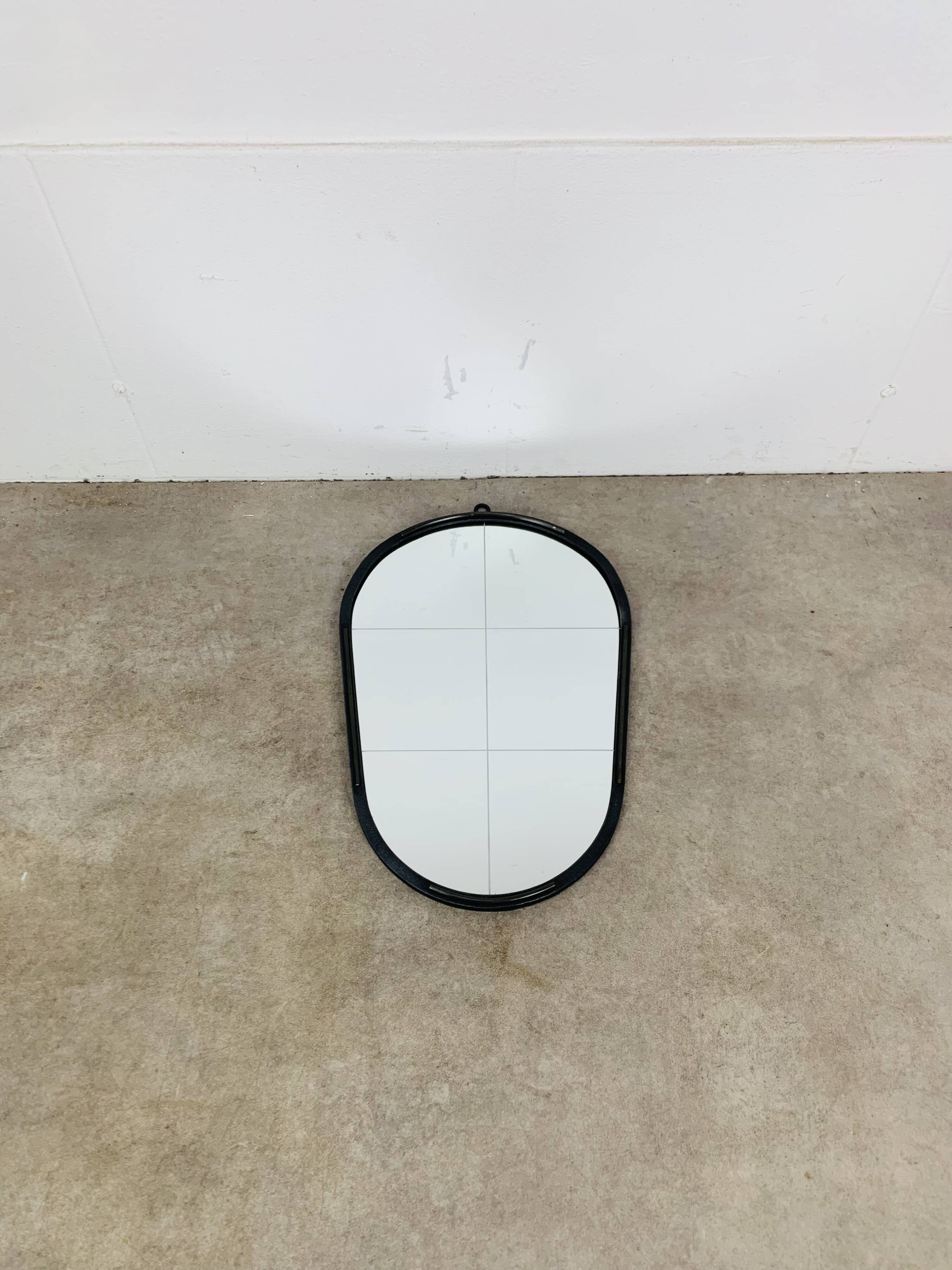 Oval mirror from the 1950s, wrought iron and brass.