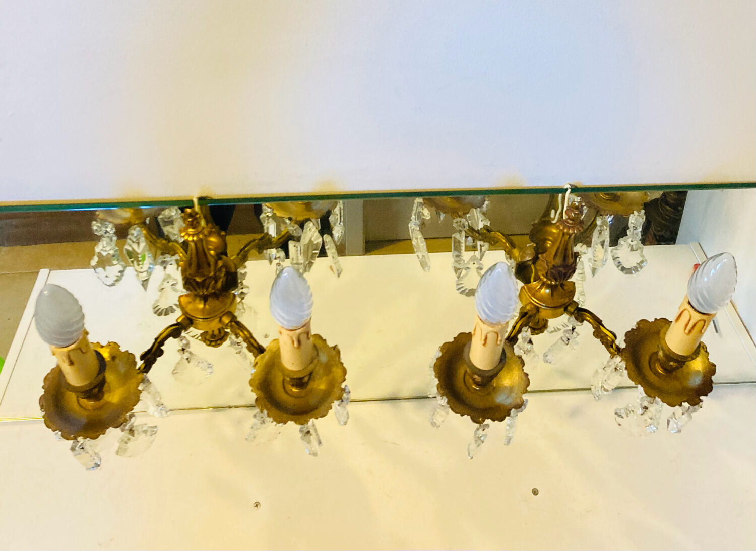 Pair of gilt bronze wall sconces with pendants from the mid-20th century.