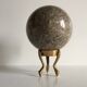 Marble ball paperweight on vintage brass