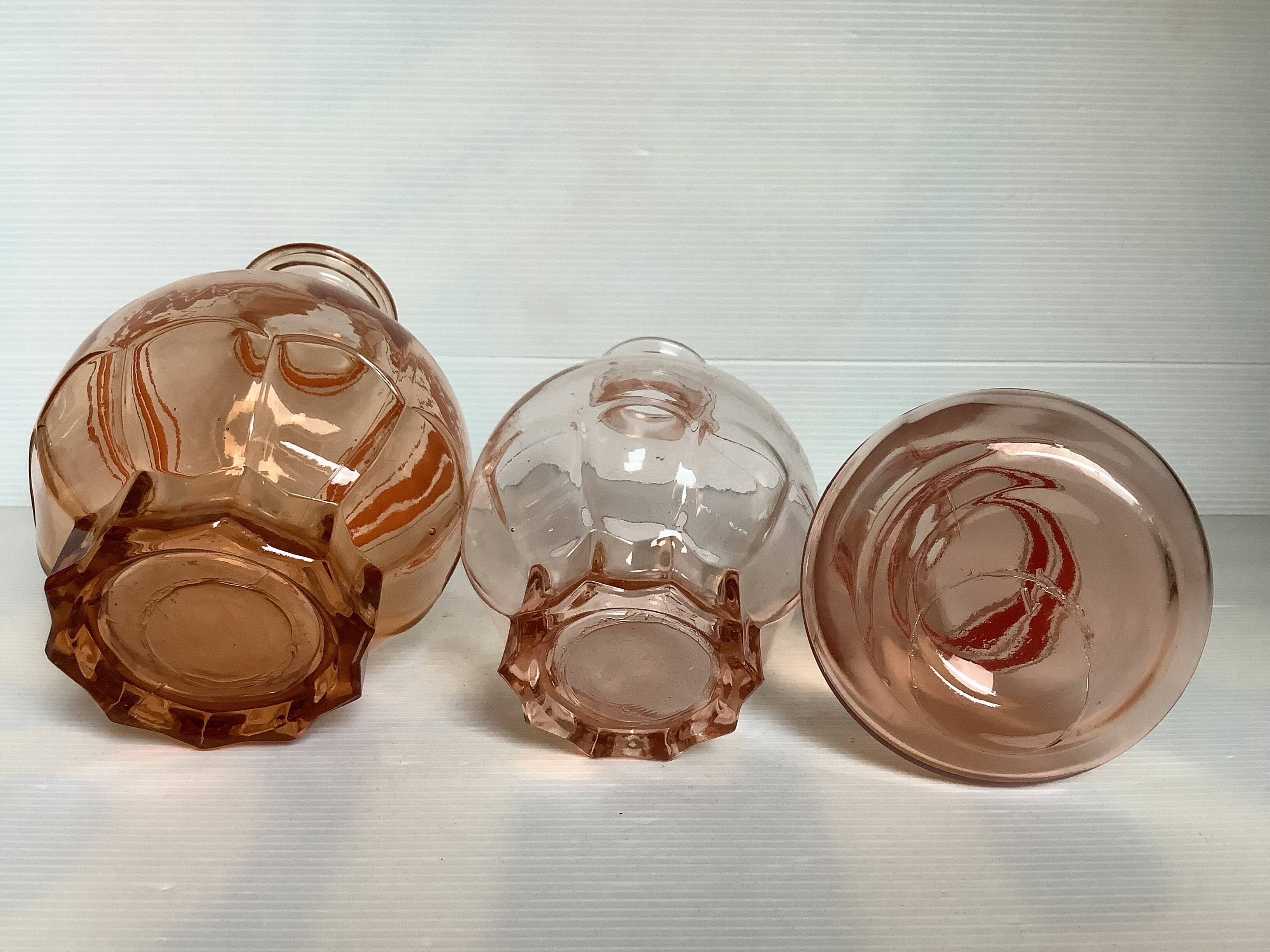 Trio of pink bottle decanters