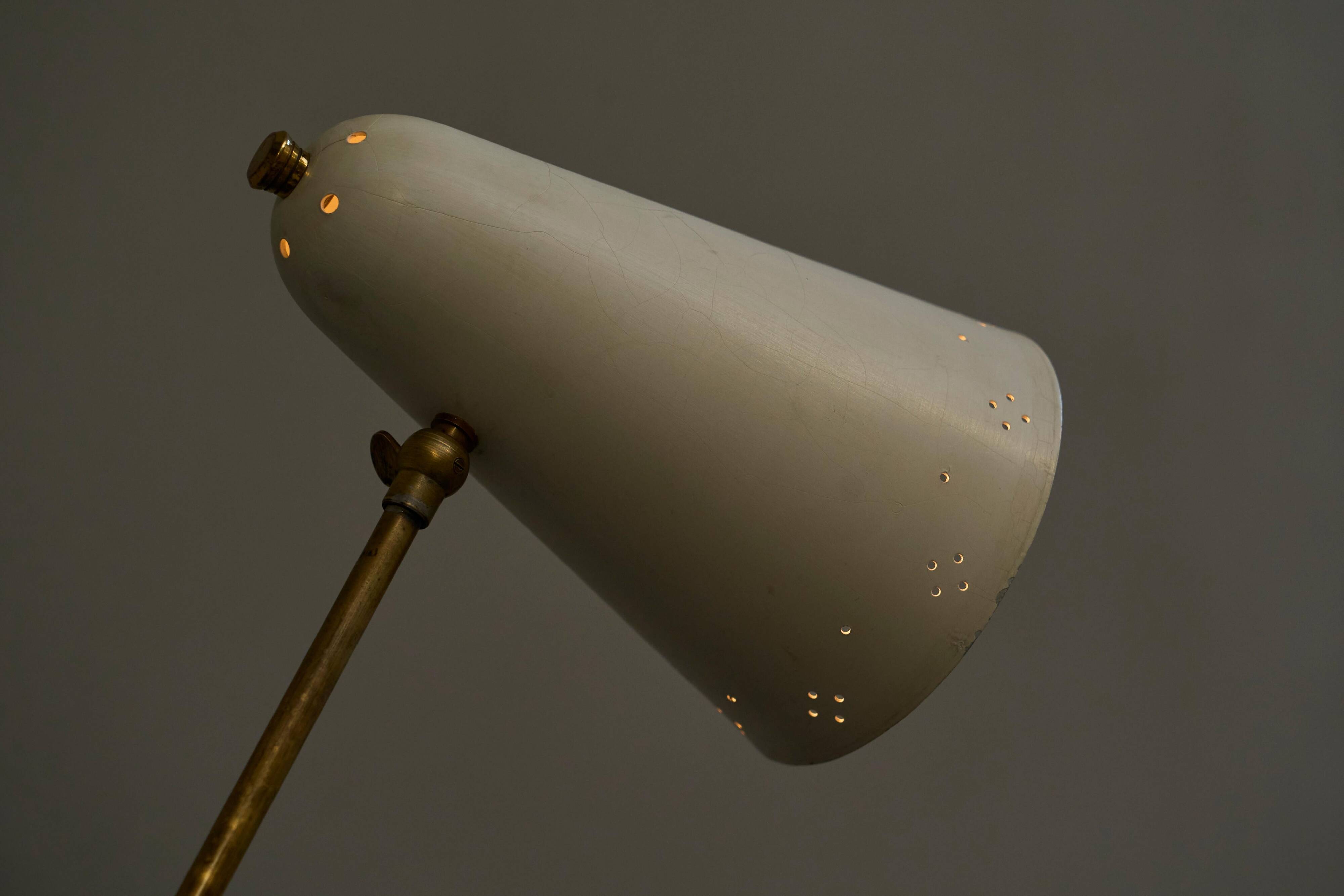 Mid Century adjustable table lamp with perforated shade from the 1950s.