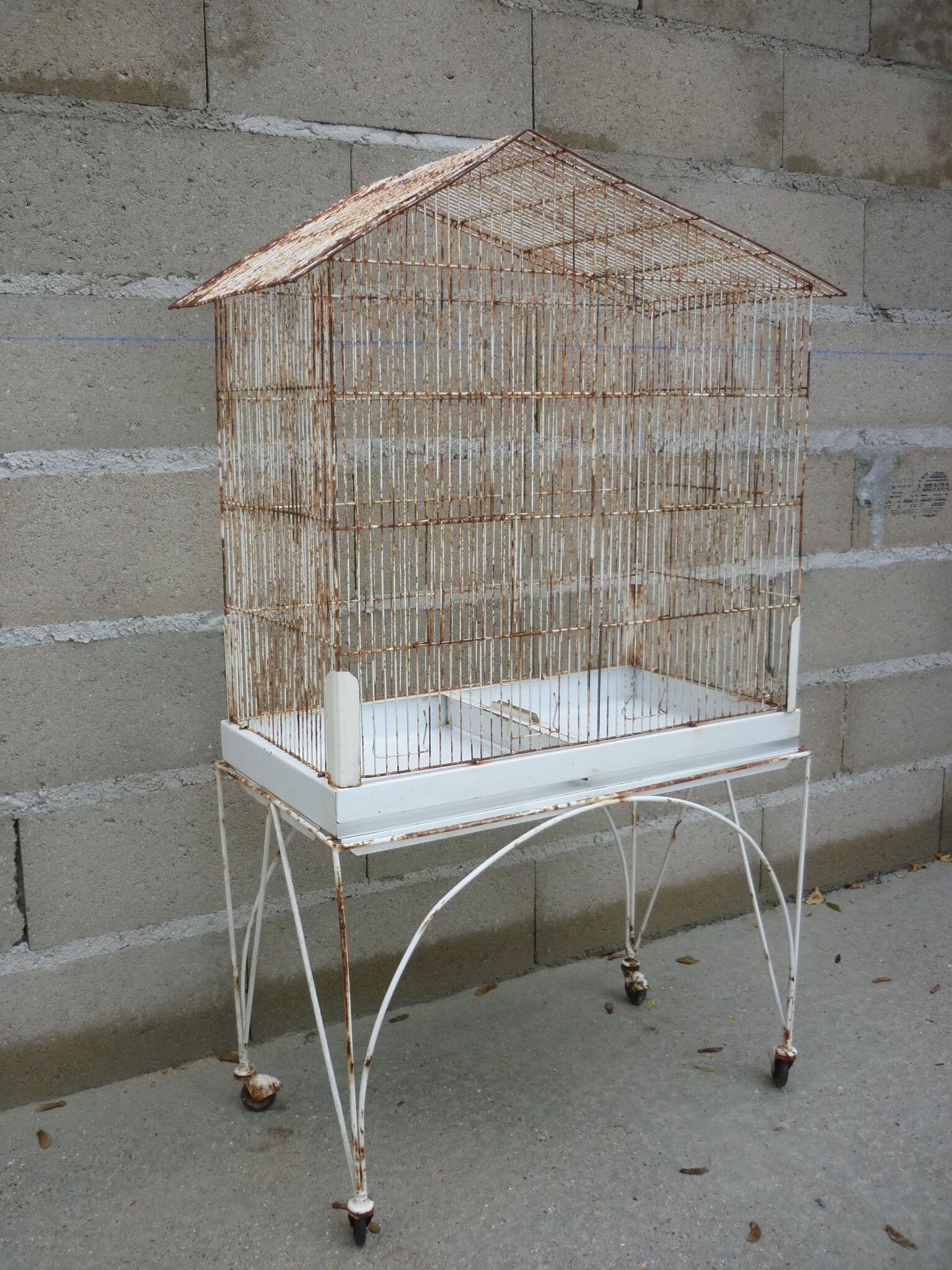 Bird cage with its wheeled holder