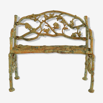 Green cast iron bench with green patina