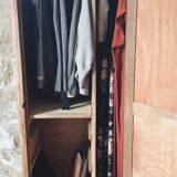 Vintage wooden wardrobe with matte cast iron color hanging rail