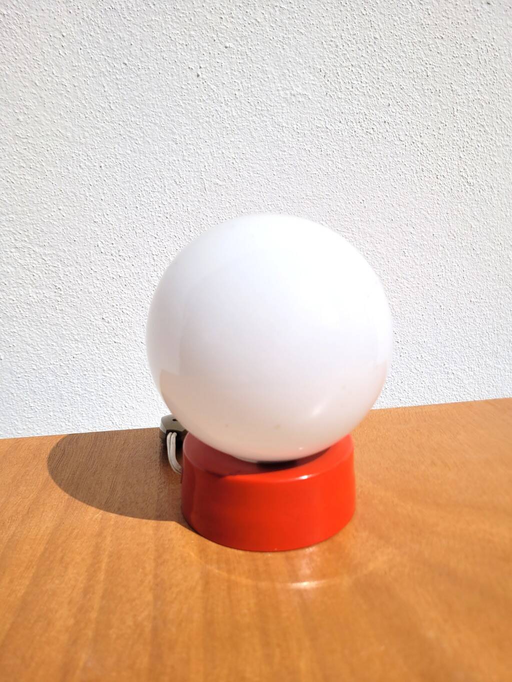 Small vintage opaline ball lamp with an orange base.