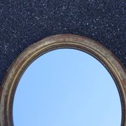 Paire de miroirs ovales en bois doré époque Louis Philippe