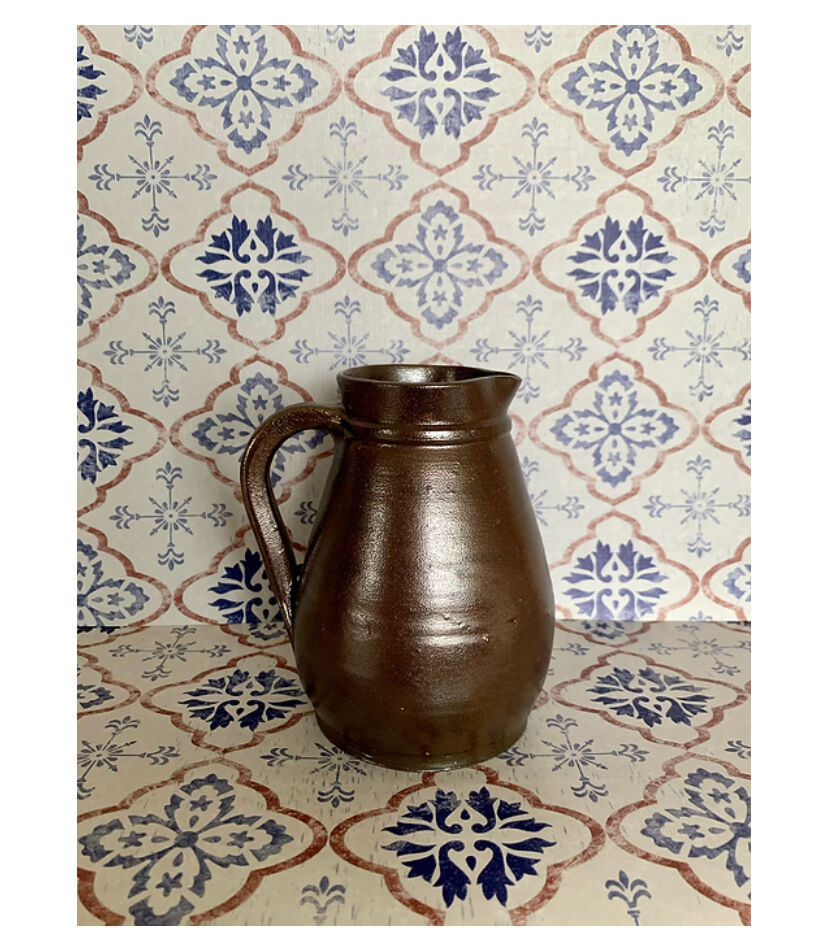 Pitcher in dark brown sandstone
