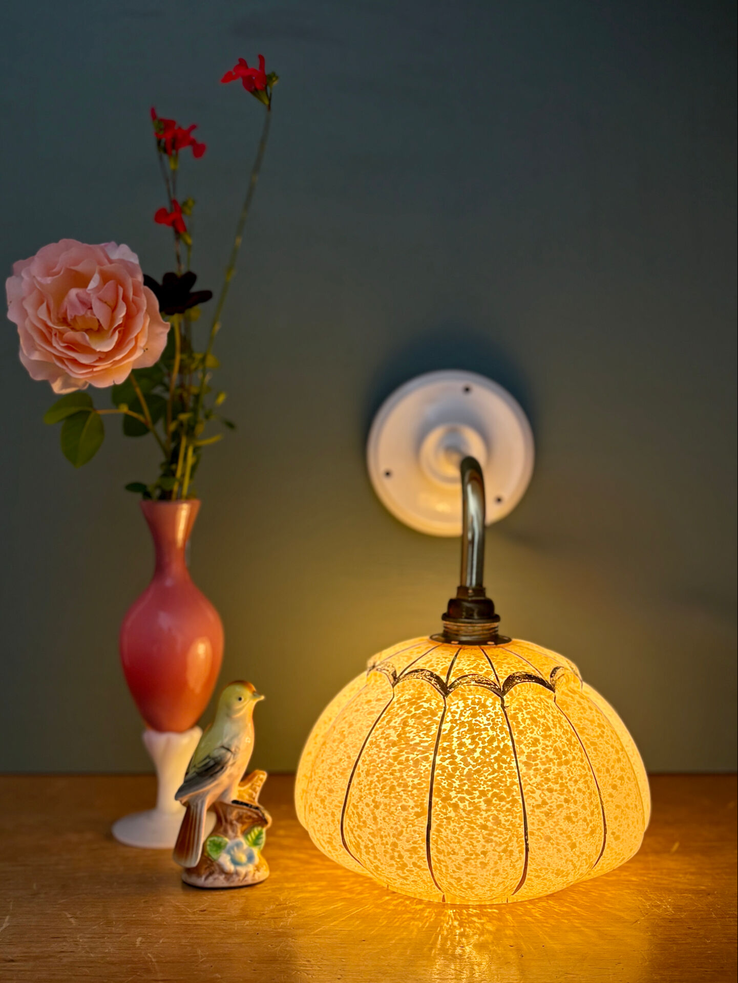 Vintage glass wall light with a pink and gold Clichy globe.