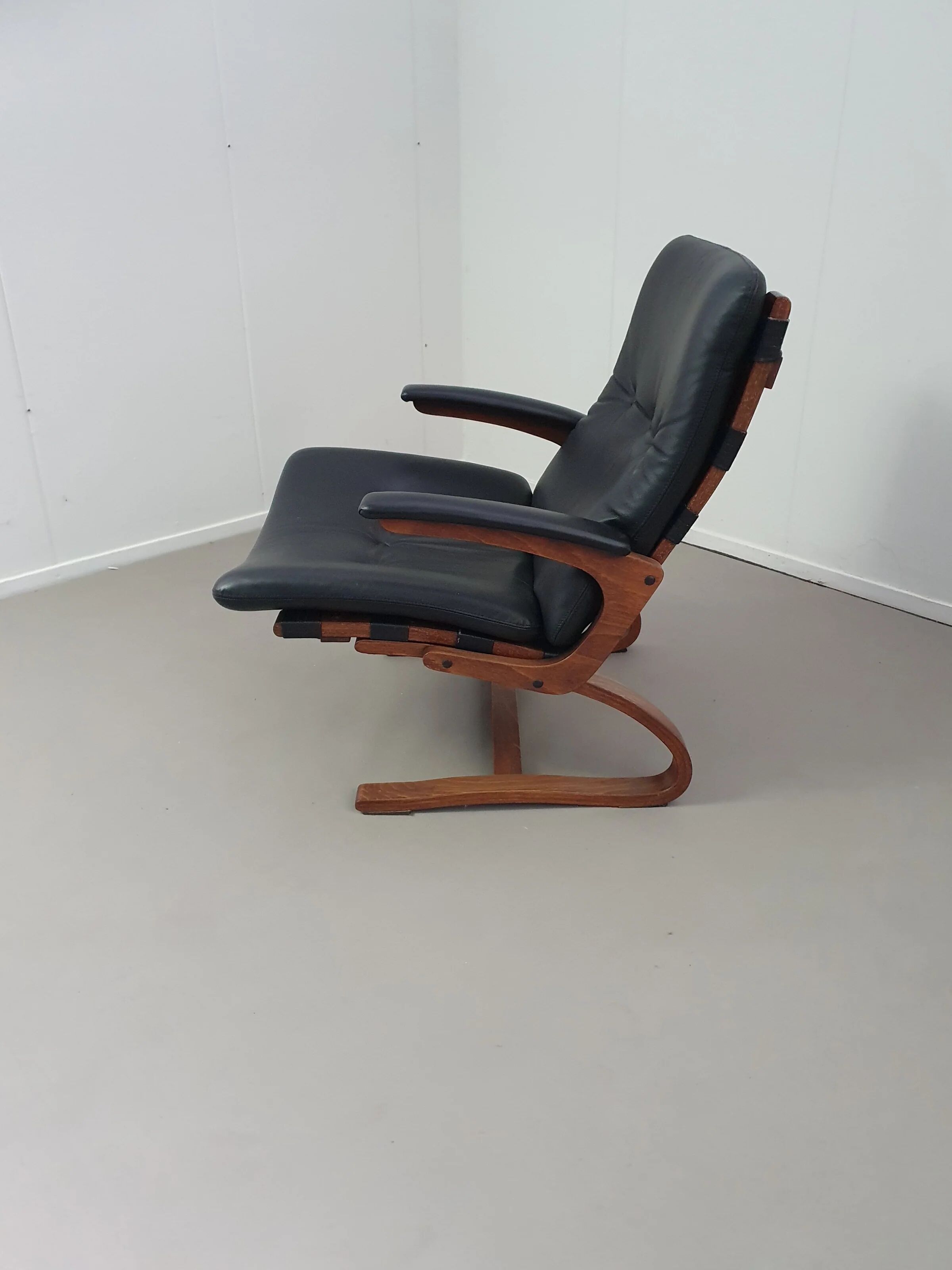 2 x Scandinavian black leather lounge chairs