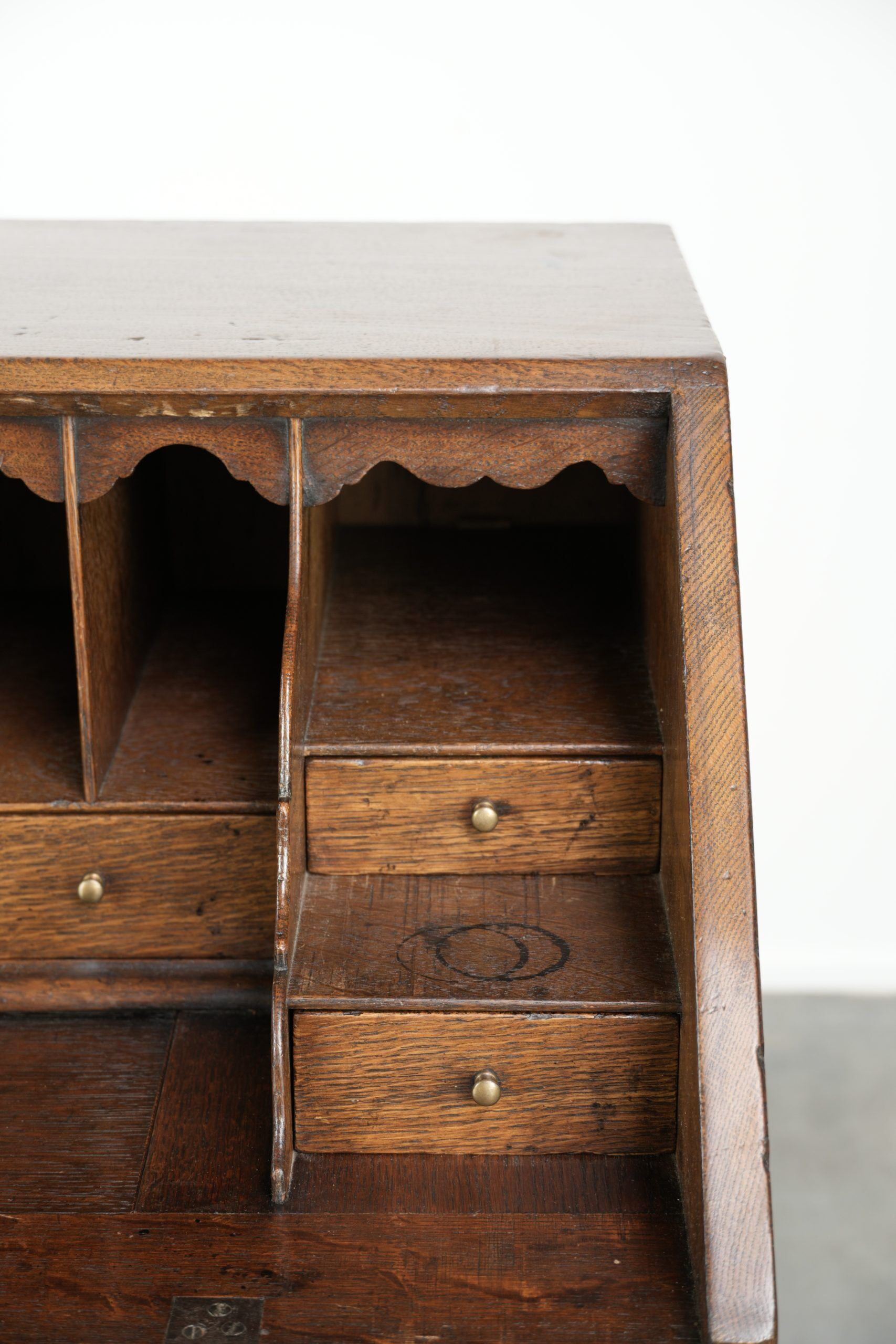 Antique English oak secretary from the 18th century with a stepped interior