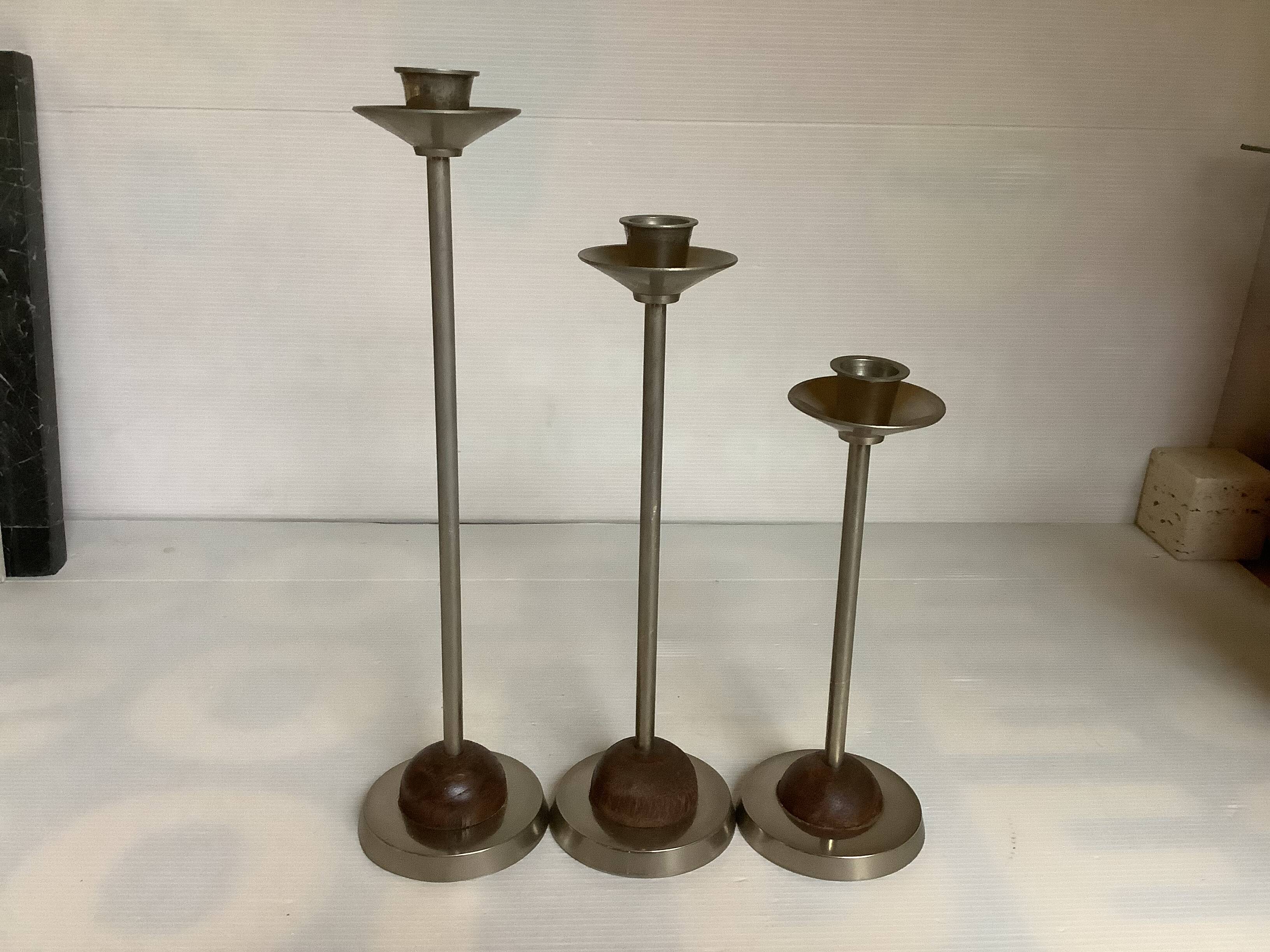 Trio of metal and wood candlesticks
