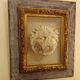 Antique gilded frame with stone lion head ornament on plexiglass