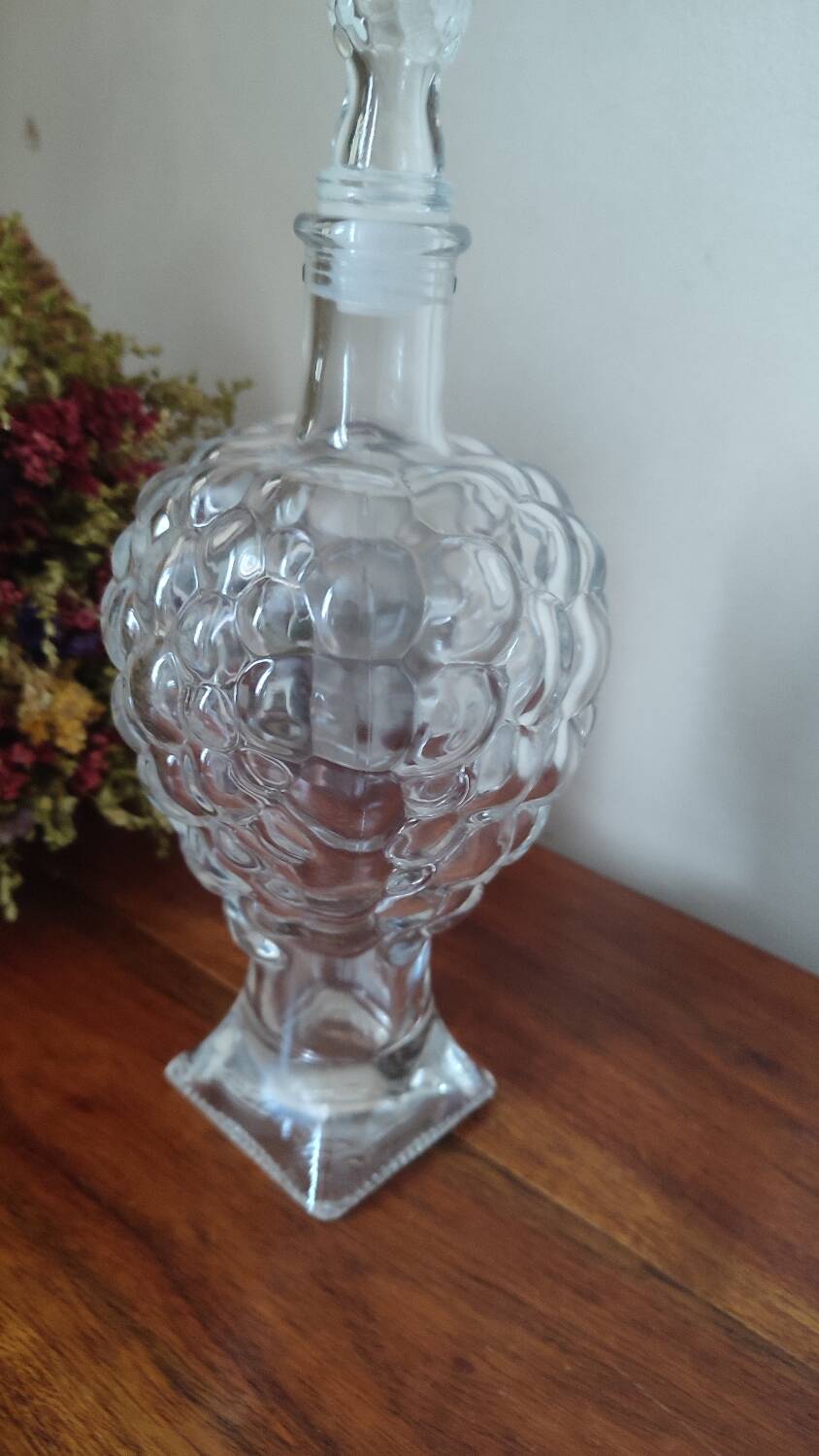 Pressed glass carafe in the shape of a bunch of grapes.