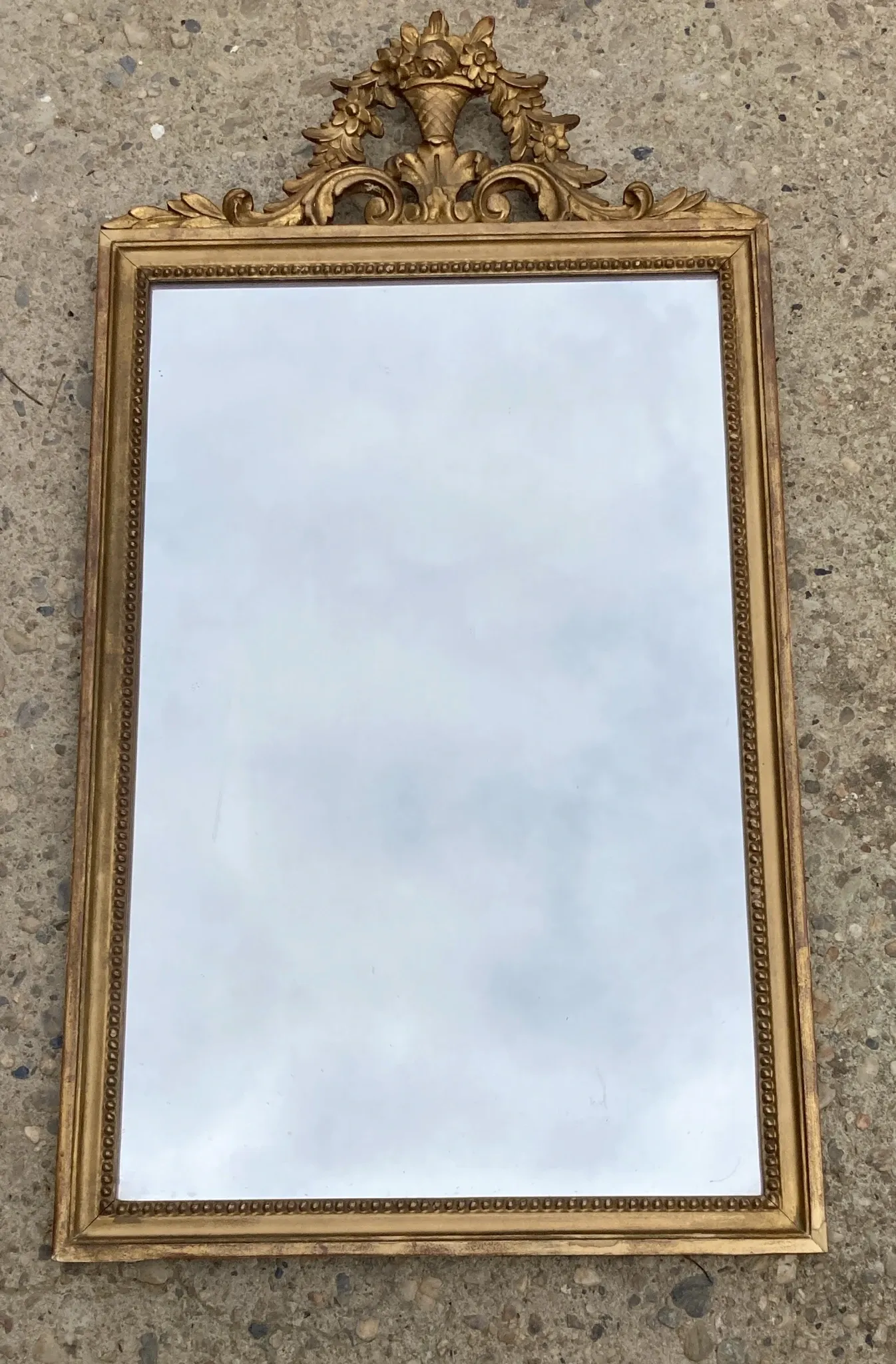 Antique mirror in wood and gilded stucco with a pediment - in the style of the 18th century.