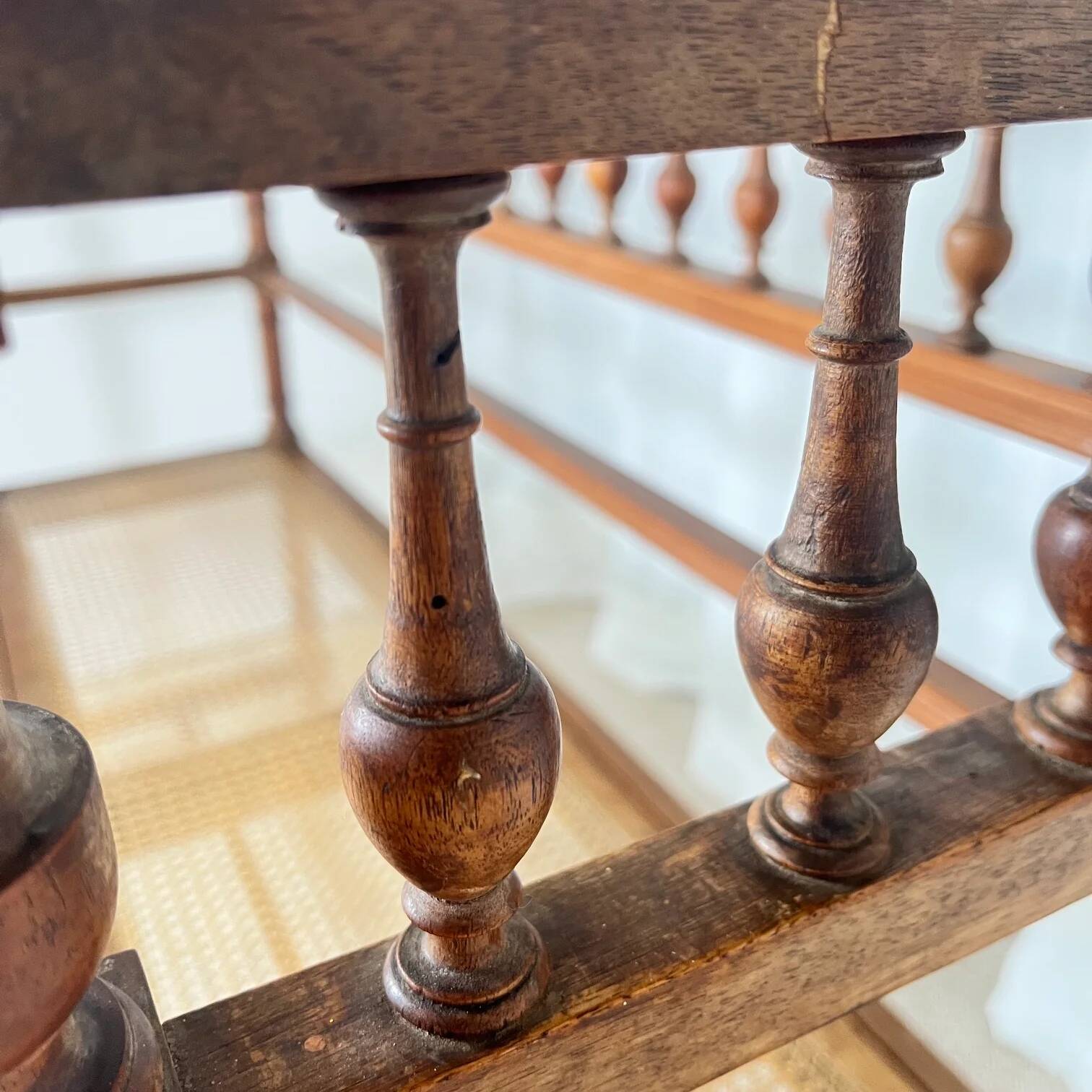 Antique banquette in Louis XIII style, turned wood with caning, late 19th to early 20th century.
