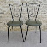 Black metal chairs with khaki faux leather seats, circa 1960.